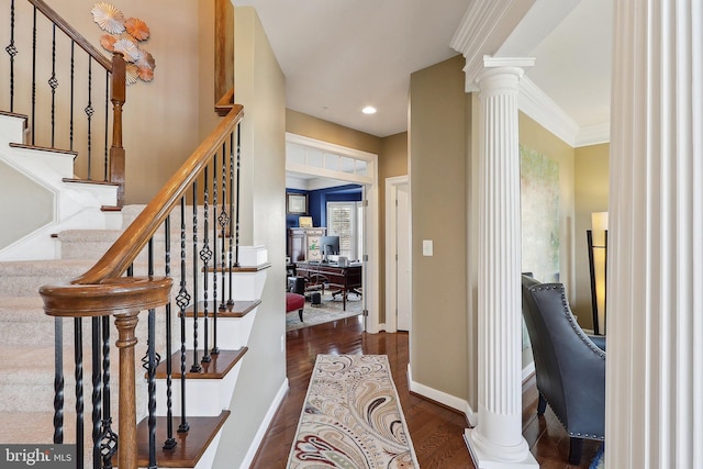 foyer featuring recessed lighting, ornate columns, ornamental molding, wood finished floors, and baseboards