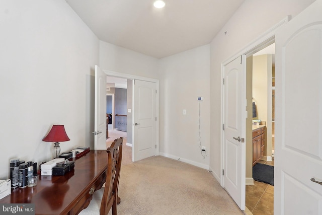 office featuring baseboards and light colored carpet