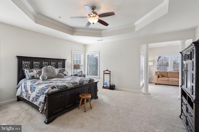 bedroom with decorative columns, baseboards, a raised ceiling, and crown molding