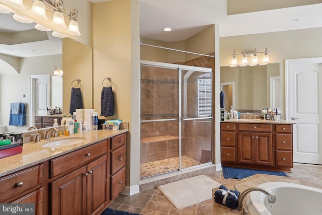 bathroom with a sink, a shower stall, and tile patterned floors