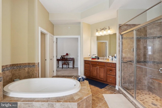 full bathroom with a stall shower, tile patterned floors, a garden tub, and vanity