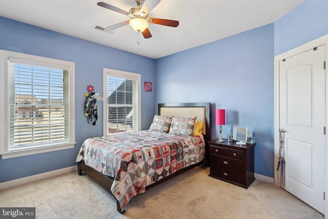 bedroom with carpet flooring, visible vents, baseboards, and multiple windows