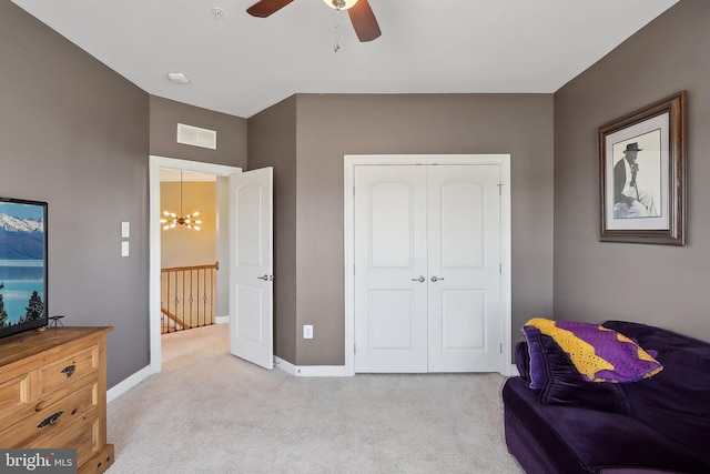 living area featuring baseboards, visible vents, light carpet, and an upstairs landing