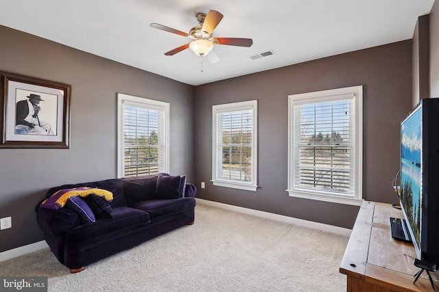 living room with ceiling fan, carpet, visible vents, and baseboards