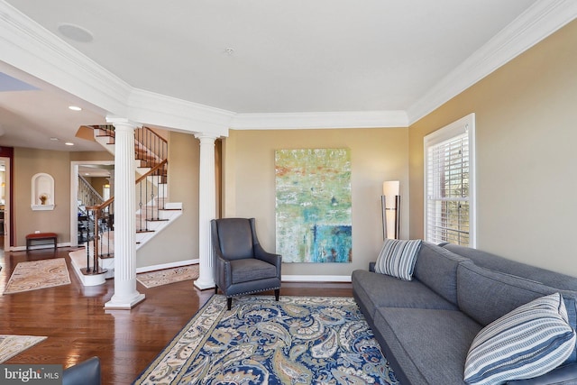 living room featuring ornate columns, stairway, wood finished floors, and ornamental molding