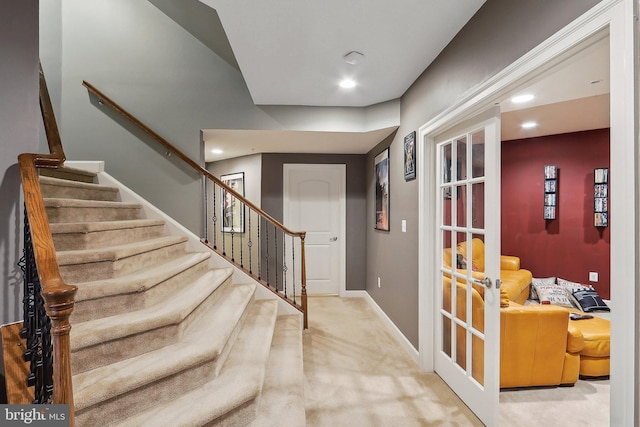 foyer entrance with recessed lighting, baseboards, french doors, stairway, and carpet