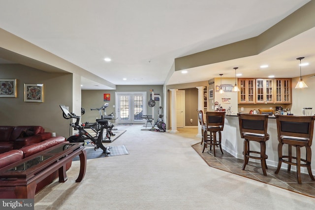 exercise area featuring recessed lighting, light carpet, french doors, indoor wet bar, and ornate columns