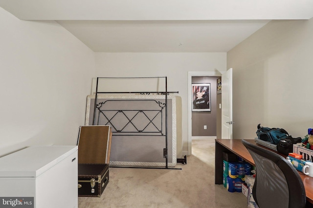 bedroom featuring refrigerator, light carpet, and baseboards