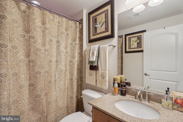 full bathroom with visible vents, vanity, and toilet