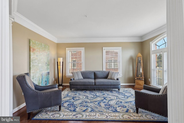 living room featuring ornamental molding, wood finished floors, and baseboards