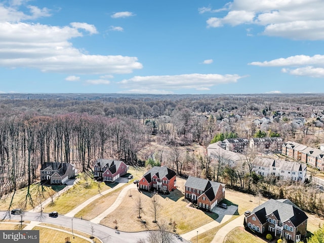 drone / aerial view with a forest view and a residential view