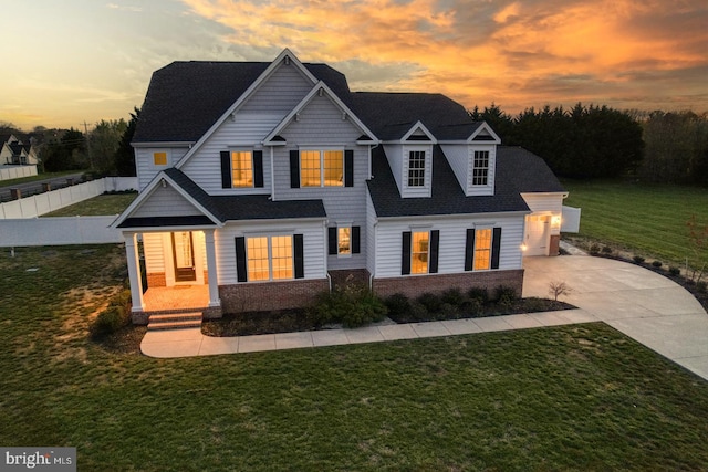 view of front of property featuring a lawn and covered porch