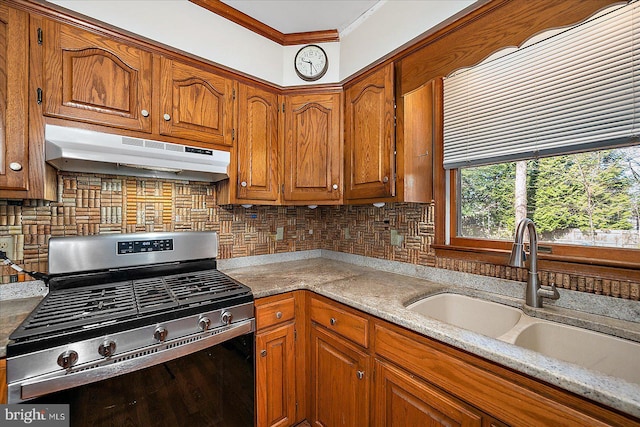 10133 Queens Cir, Ocean City, MD 21842 - kitchen featuring backsplash, a sink, brown cabinets, under cabinet range hood, and gas range