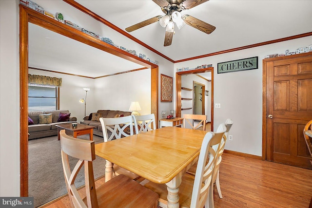 10133 Queens Cir, Ocean City, MD 21842 - dining space featuring baseboards, a ceiling fan, light wood-style flooring, and crown molding