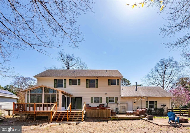 10133 Queens Cir, Ocean City, MD 21842 - rear view of house featuring a wooden deck, fence, a hot tub, a sunroom, and a patio