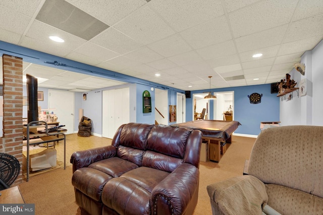 living room with a paneled ceiling, light carpet, and billiards