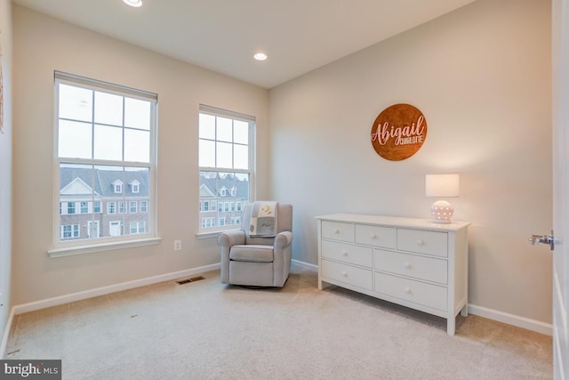 sitting room with recessed lighting, light colored carpet, visible vents, and baseboards