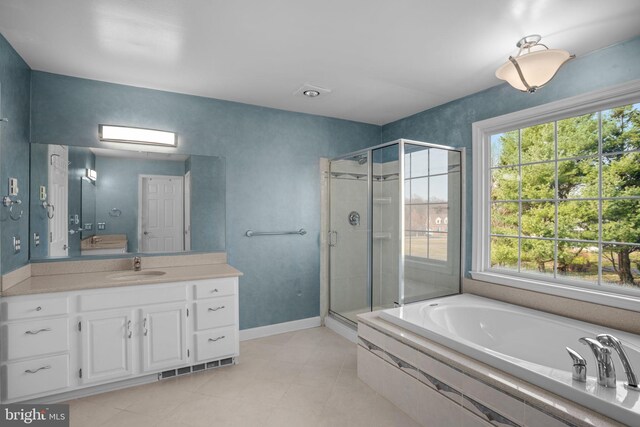 full bath featuring visible vents, a shower stall, baseboards, a garden tub, and vanity