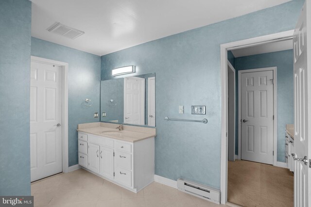 bathroom featuring vanity, baseboards, visible vents, and a baseboard radiator