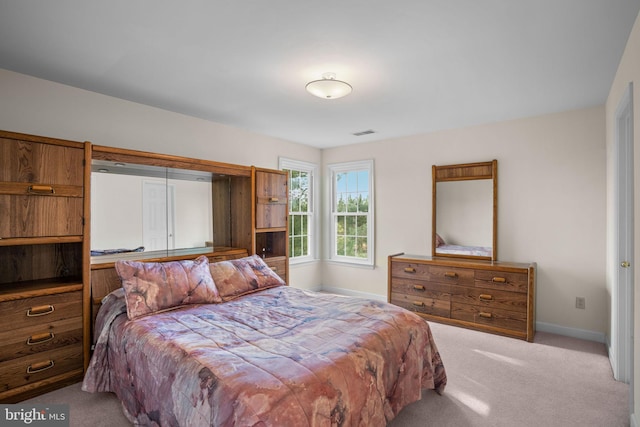 carpeted bedroom with visible vents and baseboards