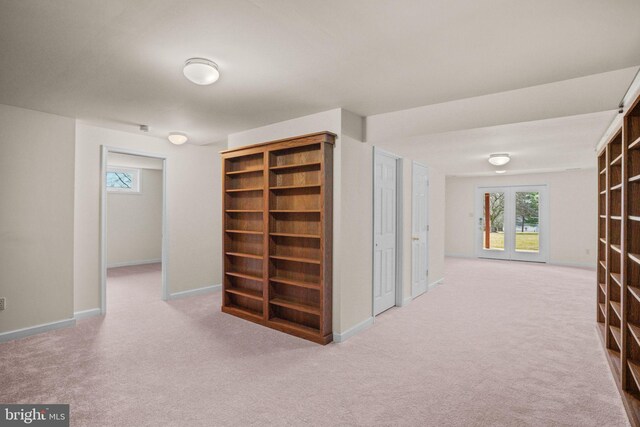 hall featuring carpet and baseboards