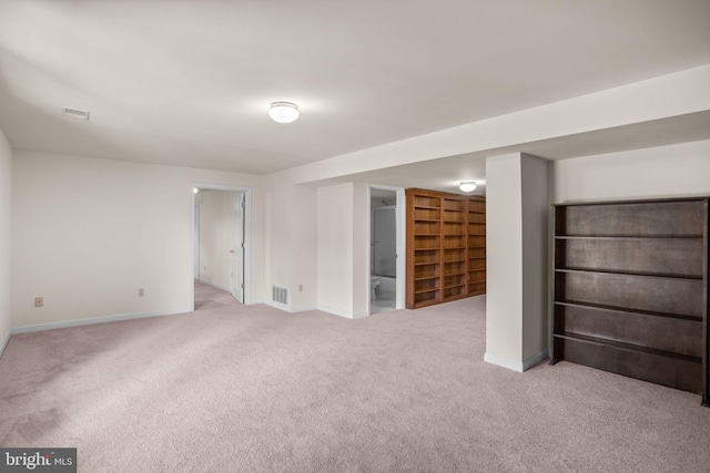 finished basement featuring visible vents, baseboards, and carpet floors