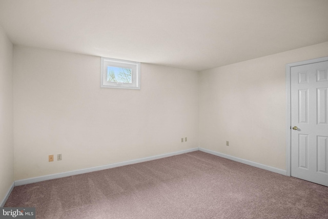 unfurnished room featuring baseboards and carpet