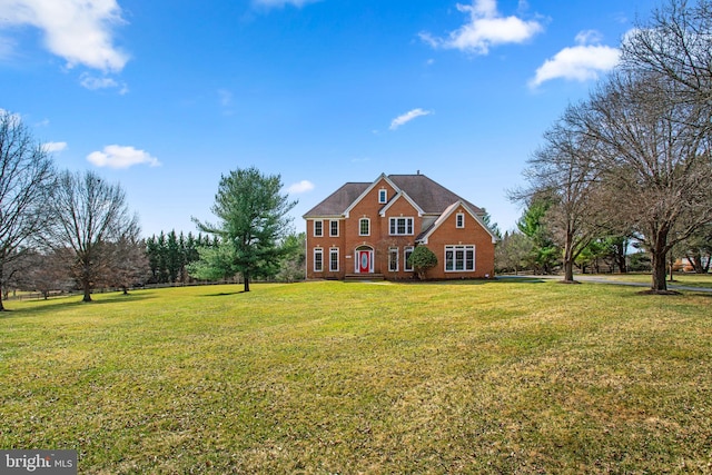 view of front of home with a front lawn and brick siding