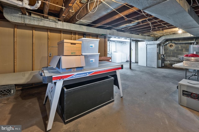 basement featuring washer and dryer and electric water heater