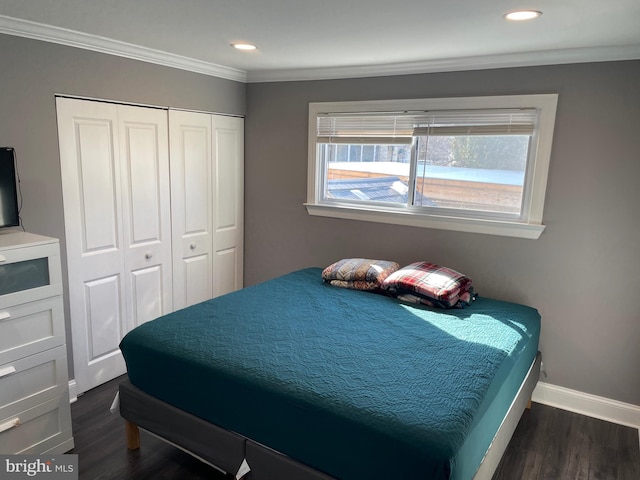 bedroom with ornamental molding, dark hardwood / wood-style floors, and a closet