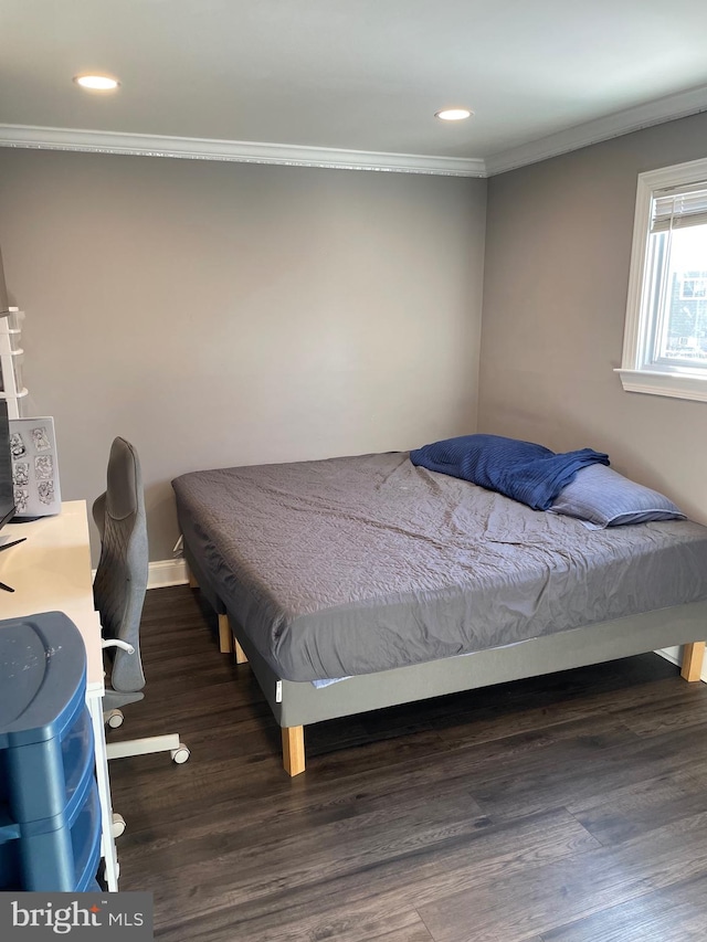 bedroom featuring ornamental molding and dark hardwood / wood-style floors