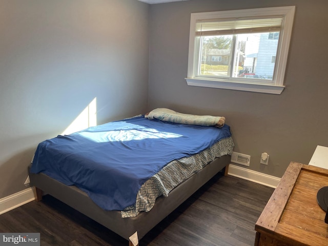 bedroom featuring dark hardwood / wood-style flooring