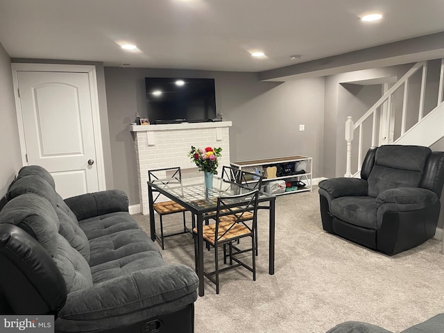 living room with carpet floors and a brick fireplace