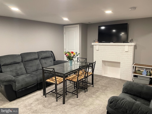 carpeted living room featuring a fireplace