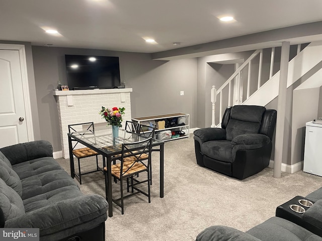 living room with carpet floors and a fireplace