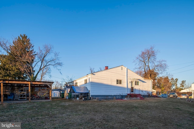 view of side of home with a lawn