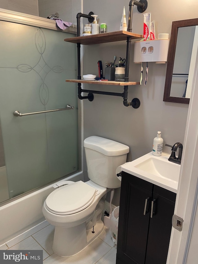 full bathroom with toilet, vanity, tile patterned flooring, and combined bath / shower with glass door