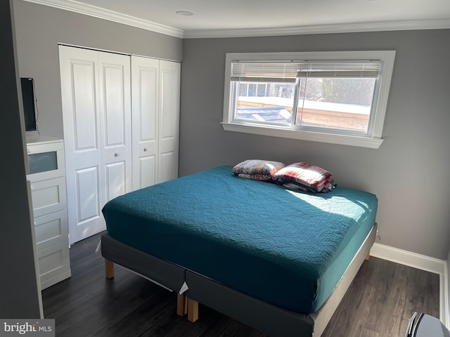 bedroom with dark hardwood / wood-style flooring, ornamental molding, and a closet