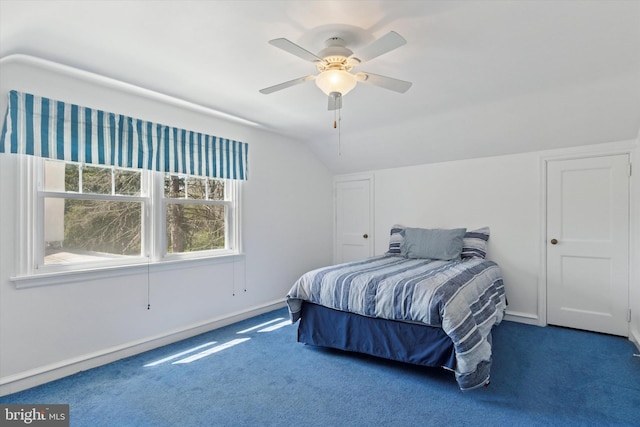 carpeted bedroom with baseboards, a ceiling fan, and vaulted ceiling