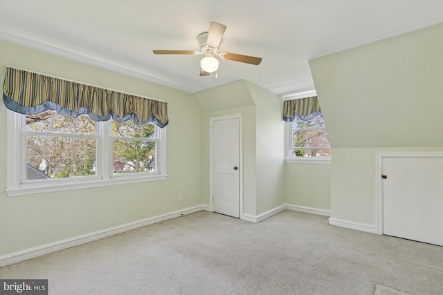 bonus room with baseboards, carpet flooring, a ceiling fan, and lofted ceiling