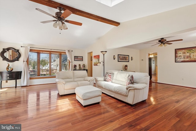 living area featuring vaulted ceiling with beams, a ceiling fan, baseboards, and wood finished floors