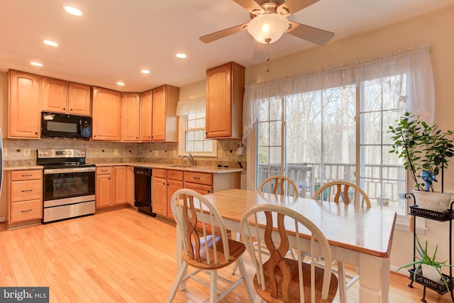 kitchen featuring sink, light hardwood / wood-style floors, black appliances, light brown cabinetry, and tasteful backsplash