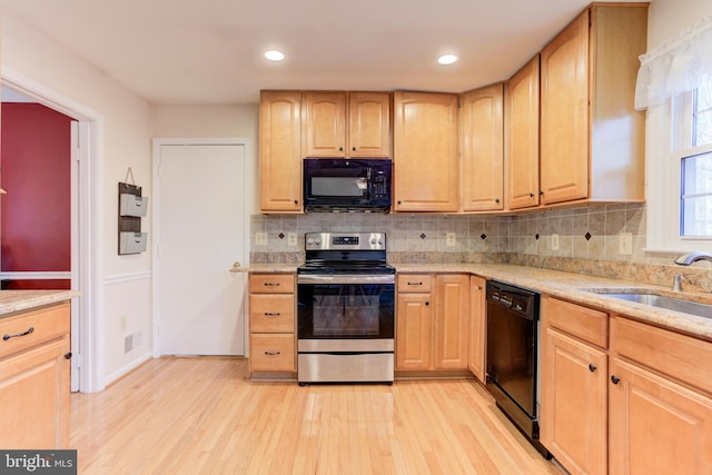 kitchen featuring light hardwood / wood-style flooring, black appliances, sink, tasteful backsplash, and light brown cabinetry