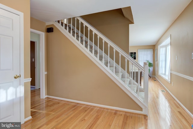 stairs with hardwood / wood-style flooring