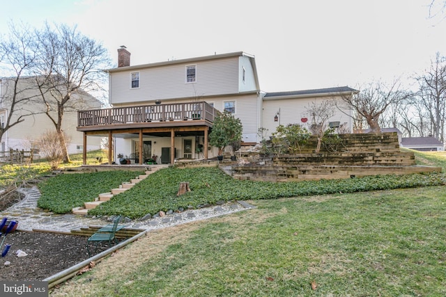 back of house with a lawn and a wooden deck