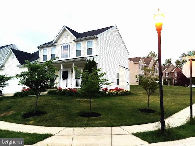 view of front of house with a porch and a front yard