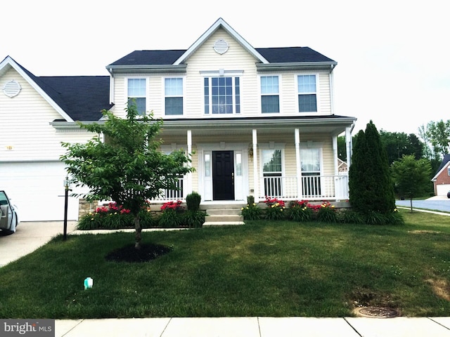 view of front of property with a garage, covered porch, and a front lawn