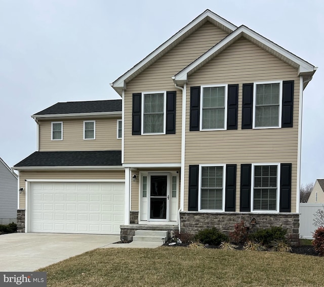 view of front of property featuring a garage and a front yard