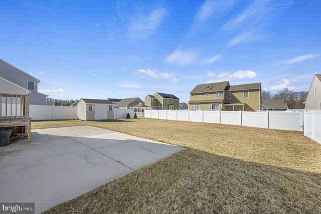 view of yard with a storage unit and a patio