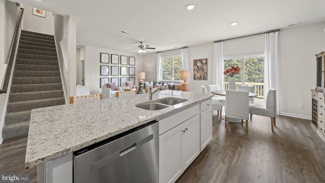 kitchen with sink, white cabinets, dark hardwood / wood-style flooring, a kitchen island with sink, and stainless steel dishwasher